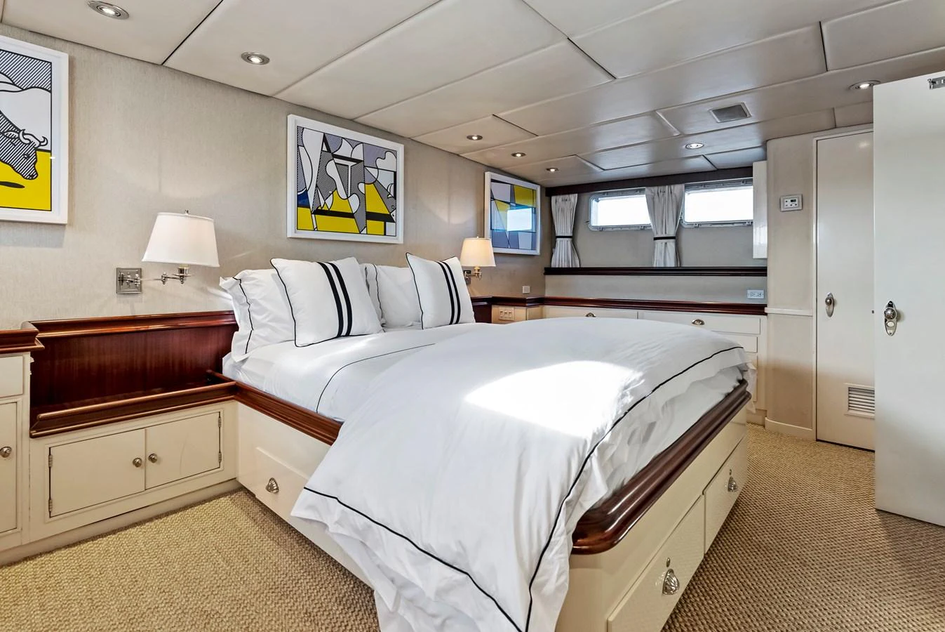 The stateroom features a comfortable bed with elegant bedding and modern artwork, creating a cozy and inviting atmosphere. aboard CHANTICLEER Yacht for Sale