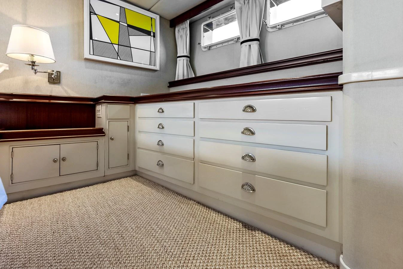The yacht's interior features a well-appointed storage area with ample cabinetry and modern decor. aboard CHANTICLEER Yacht for Sale