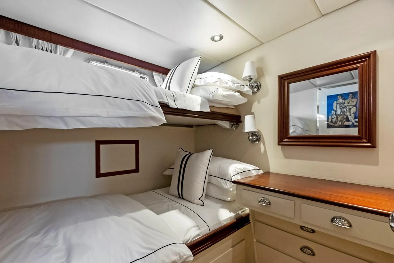 The cozy guest cabin features bunk beds and elegant wood accents. aboard CHANTICLEER Yacht for Sale