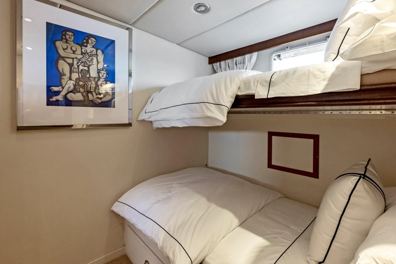 The guest cabin features cozy bunk beds and tasteful artwork, creating a welcoming atmosphere. aboard CHANTICLEER Yacht for Sale