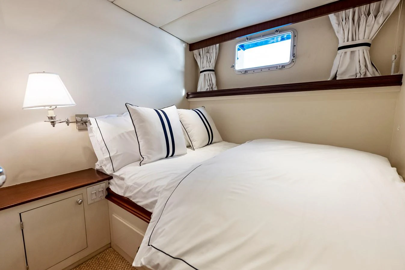 The guest cabin offers a cozy and inviting space with a comfortable bed and soft lighting. aboard CHANTICLEER Yacht for Sale