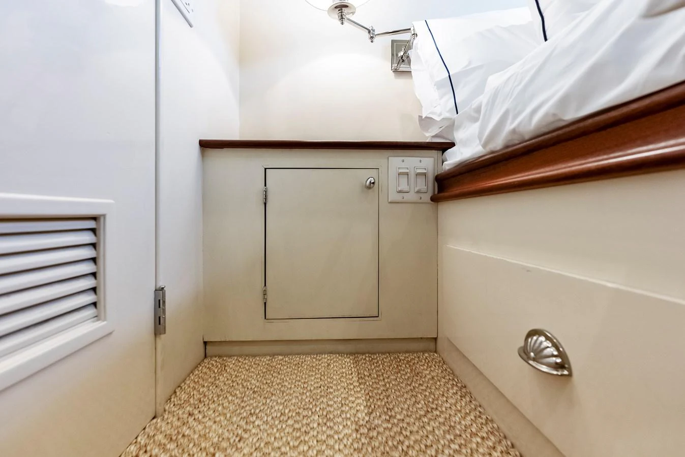 A cozy interior space featuring a small cabinet and a comfortable bed with white linens. aboard CHANTICLEER Yacht for Sale