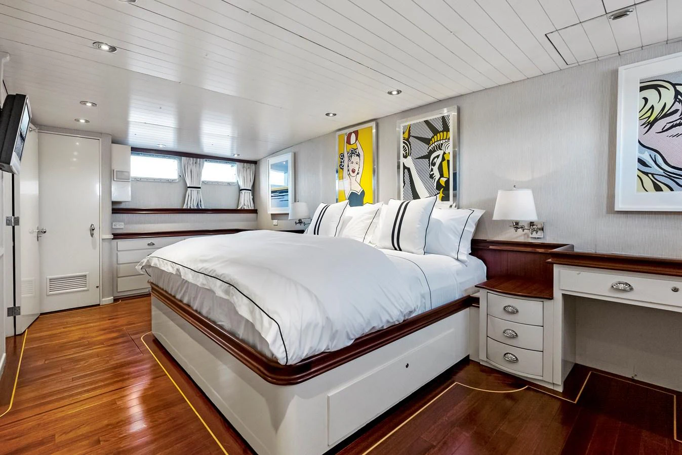 The master stateroom features a luxurious bed with crisp white linens and elegant decor. aboard CHANTICLEER Yacht for Sale