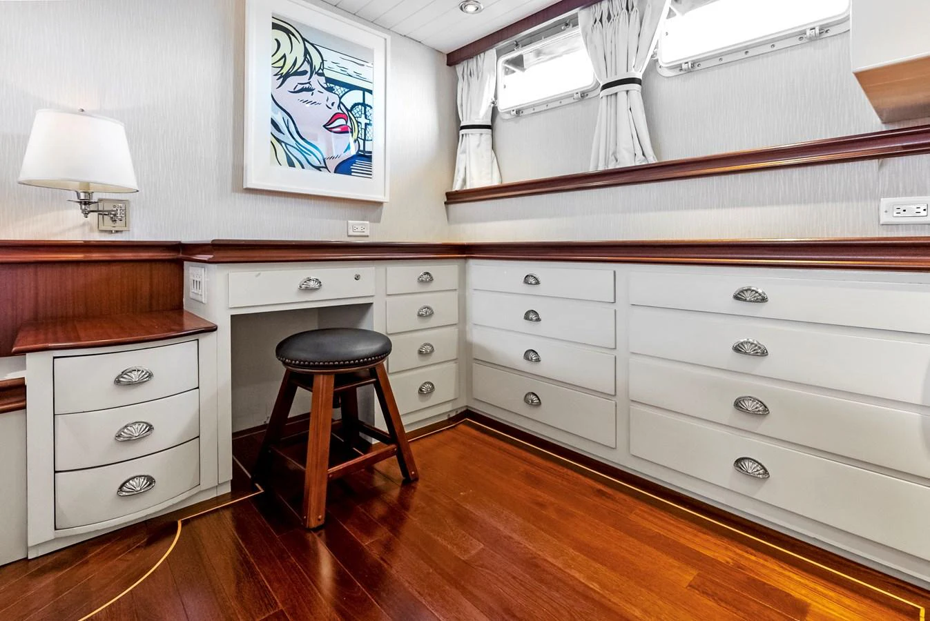A well-appointed cabin with ample storage and a stylish stool. aboard CHANTICLEER Yacht for Sale