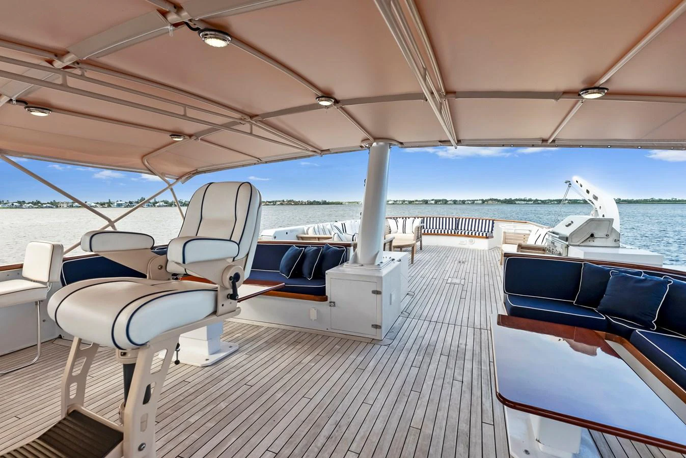 The spacious aft deck features comfortable seating and a shaded area for relaxation. aboard CHANTICLEER Yacht for Sale