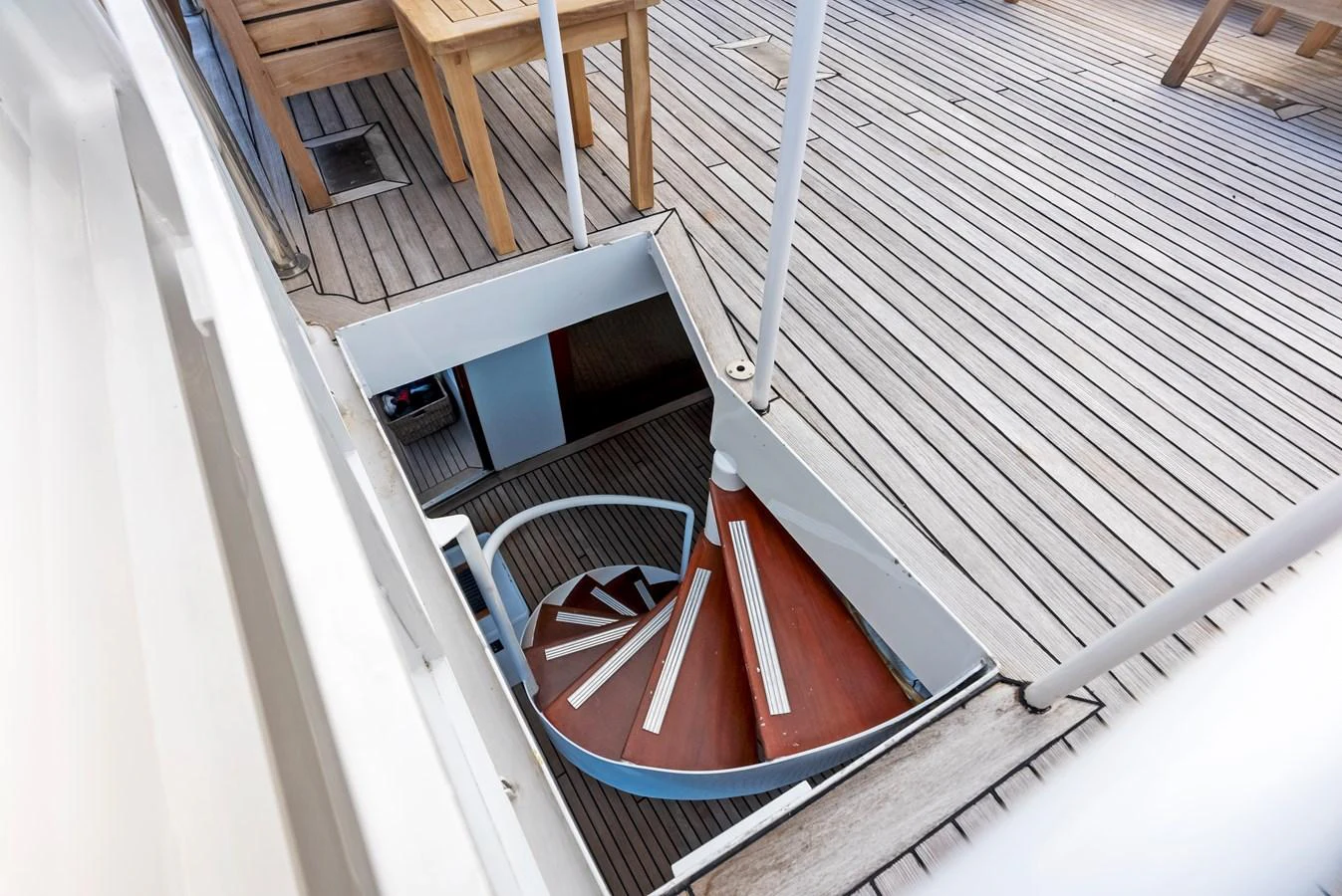 A stylish spiral staircase leads from the deck to the interior of the yacht. aboard CHANTICLEER Yacht for Sale