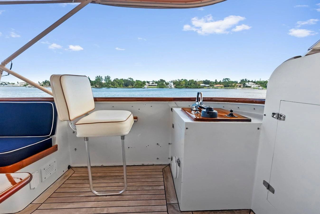 The flybridge offers a serene view over the water with comfortable seating and a helm station. aboard CHANTICLEER Yacht for Sale