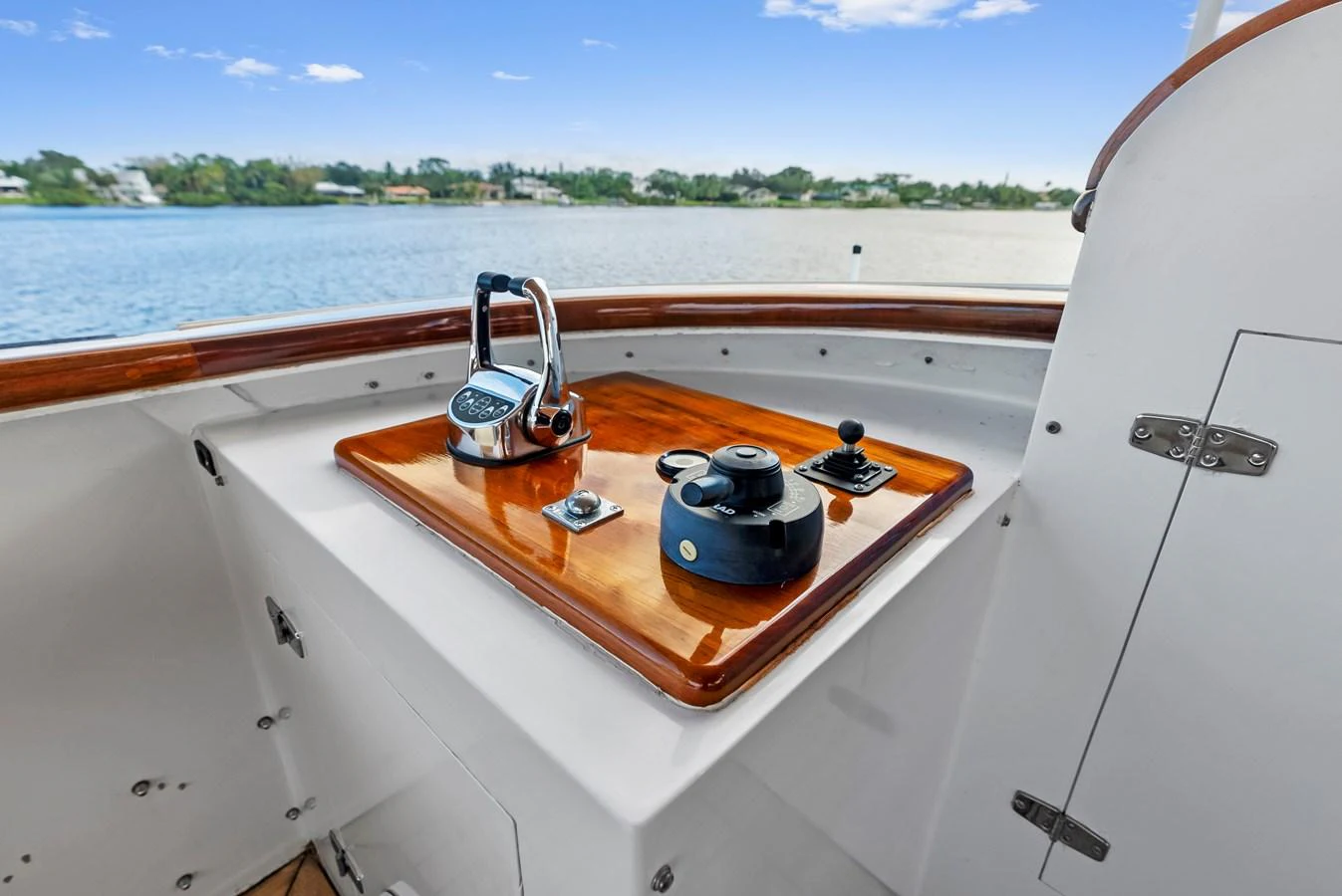 A close-up view of the yacht's helm station showcasing its controls and polished wood finish. aboard CHANTICLEER Yacht for Sale