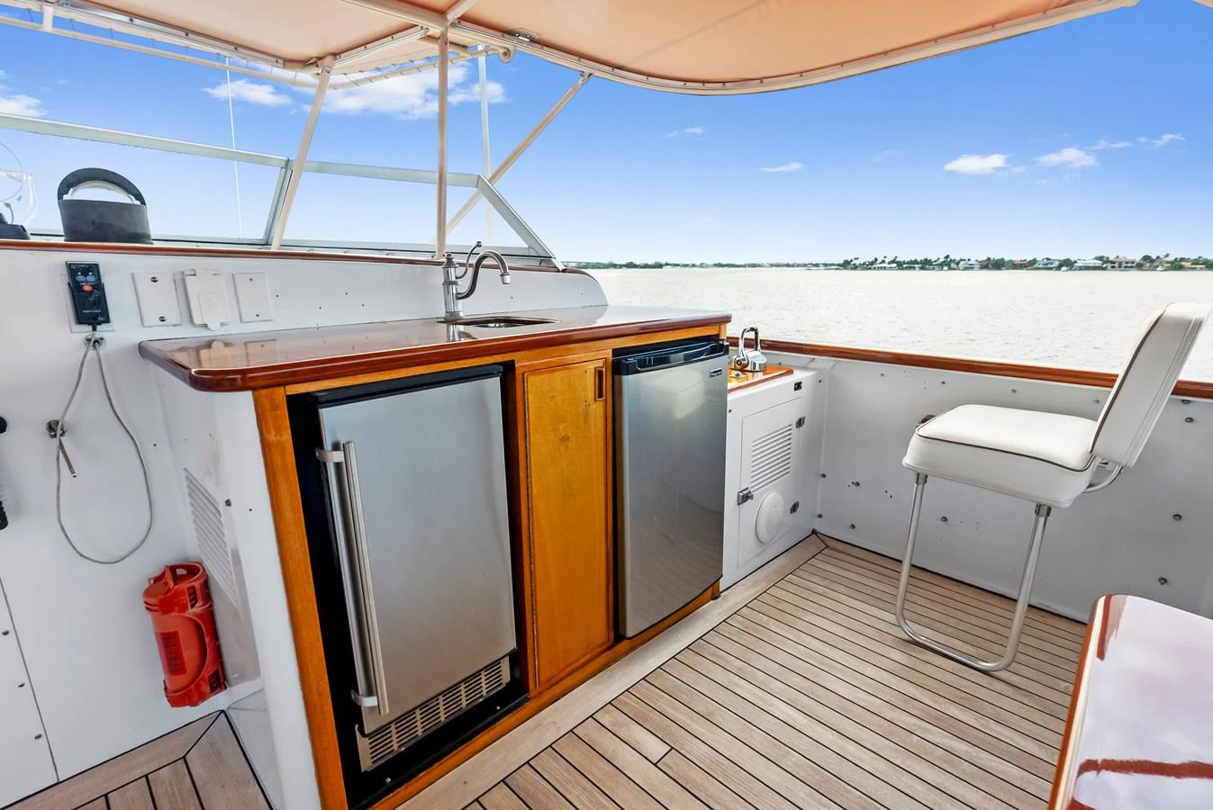 The yacht's galley features modern appliances and a comfortable seating area with a view of the water. aboard CHANTICLEER Yacht for Sale