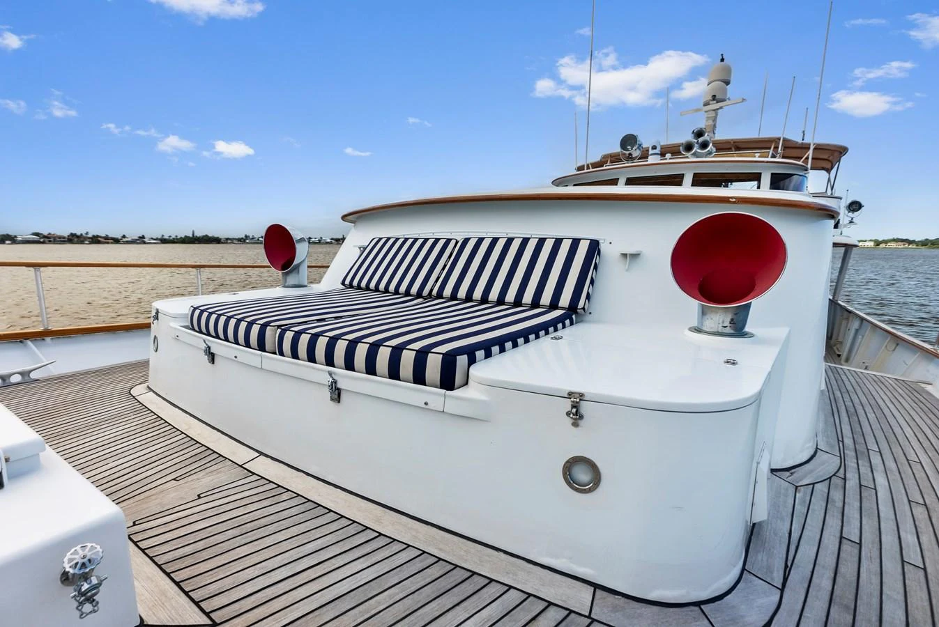 The foredeck features a stylish sunpad with striped cushions, perfect for relaxation. aboard CHANTICLEER Yacht for Sale