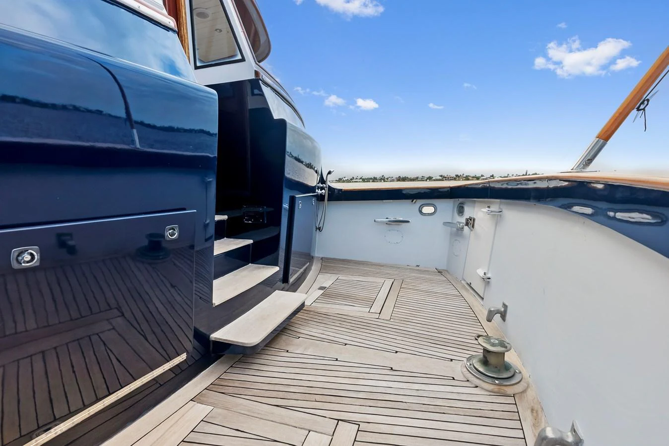 The yacht's deck features sleek wooden flooring and polished railings, offering a refined outdoor space. aboard CHANTICLEER Yacht for Sale