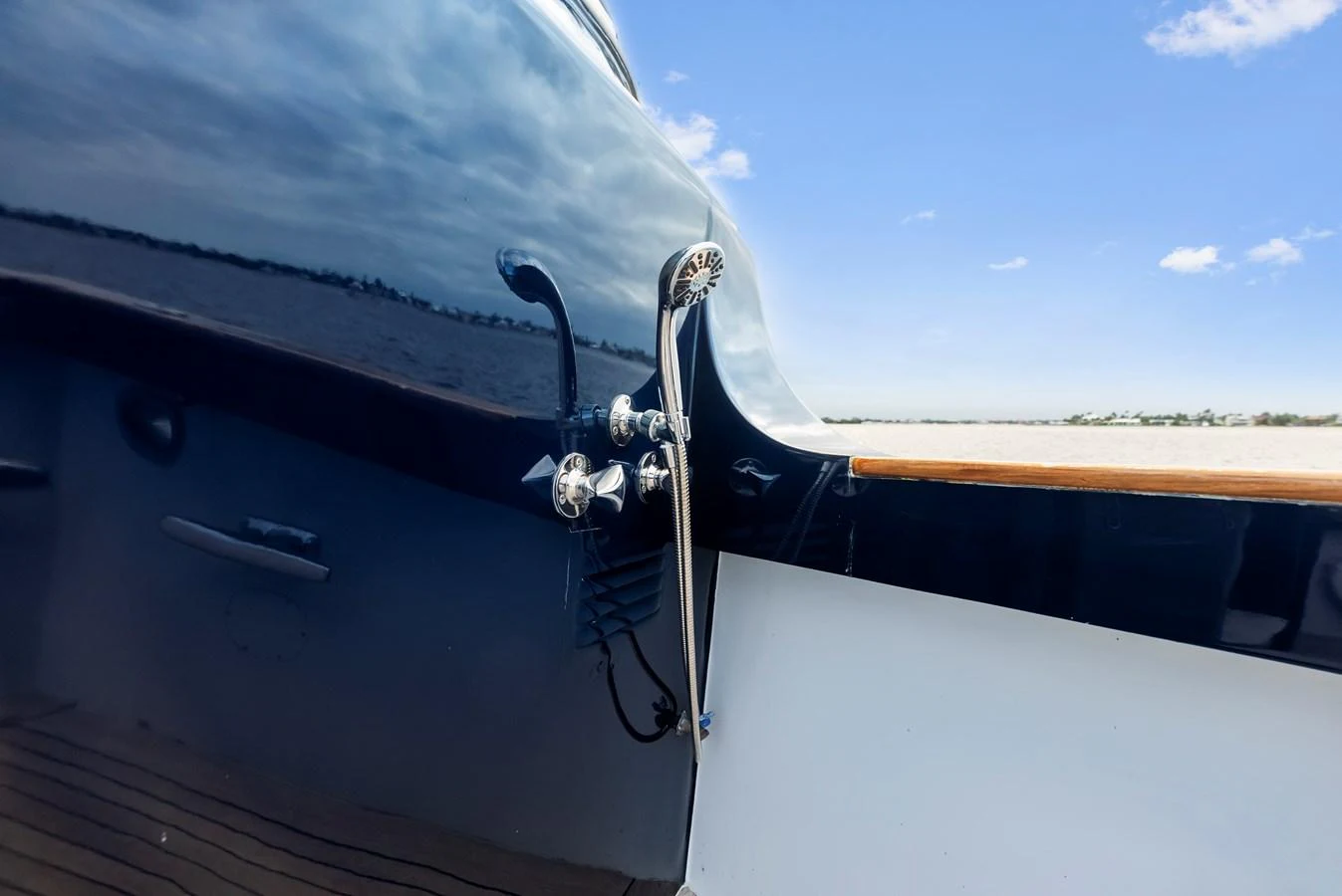 A close-up of the yacht's exterior showcasing polished metal fixtures against a sleek, dark hull. aboard CHANTICLEER Yacht for Sale
