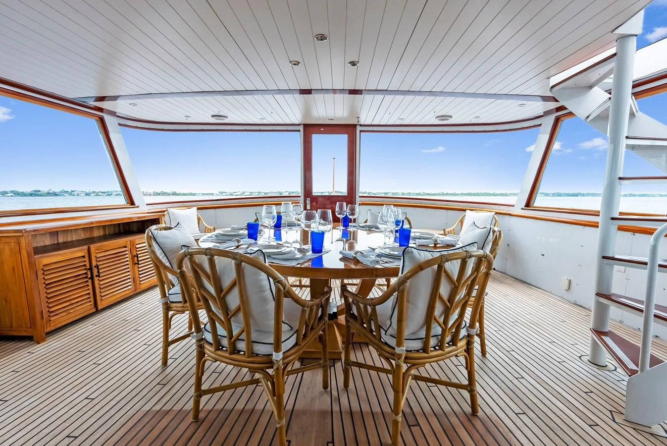 The aft deck features an elegant dining area with panoramic views of the sea. aboard CHANTICLEER Yacht for Sale