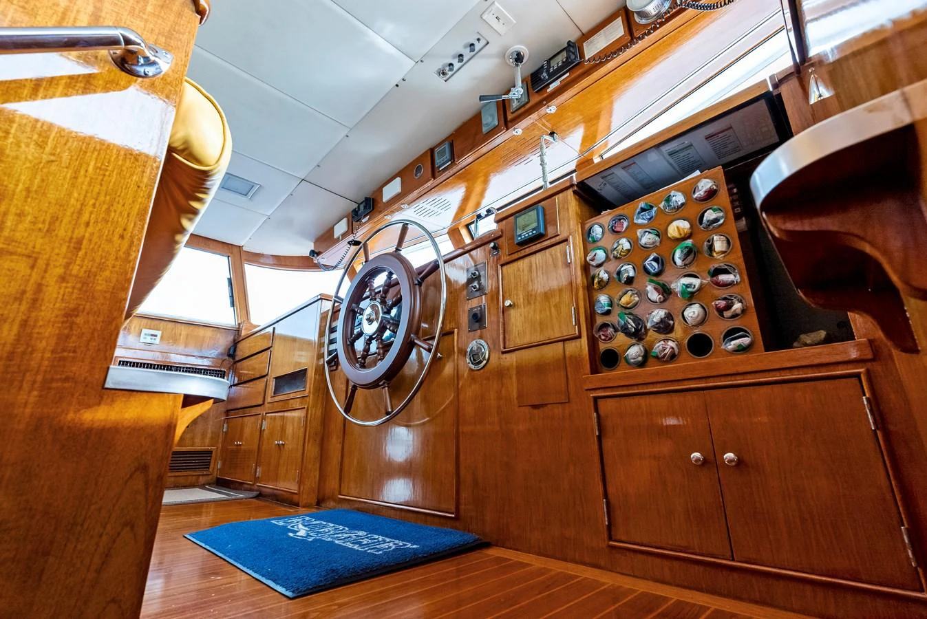 The helm of the yacht features polished wood finishes and a classic steering wheel, exuding timeless elegance. aboard CHANTICLEER Yacht for Sale