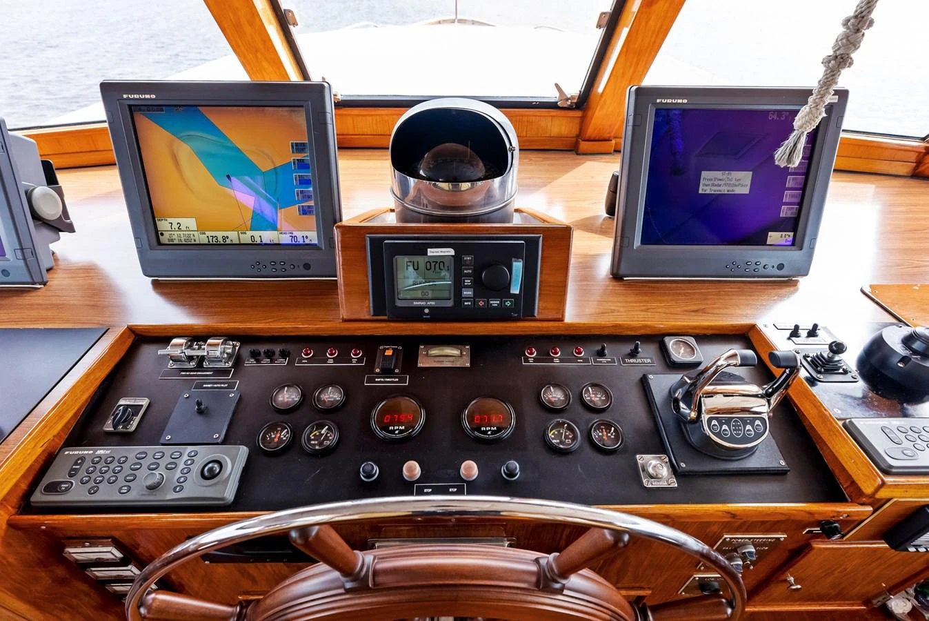 The helm station features advanced navigation equipment and classic wooden accents. aboard CHANTICLEER Yacht for Sale