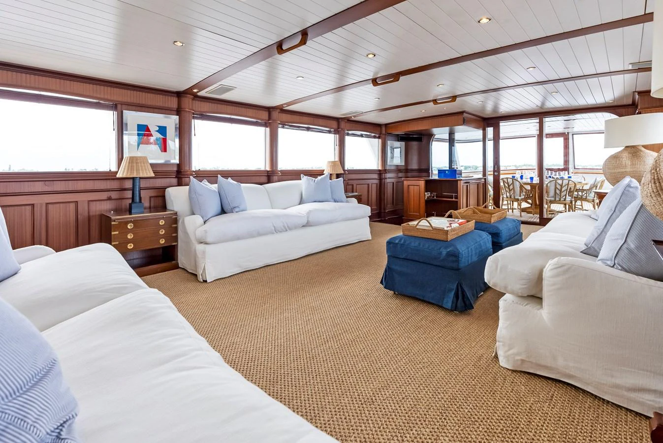 The salon features comfortable seating with plush sofas and a warm, inviting atmosphere. aboard CHANTICLEER Yacht for Sale