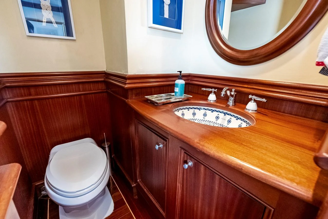 A beautifully appointed bathroom with wooden cabinetry and elegant fixtures. aboard CHANTICLEER Yacht for Sale