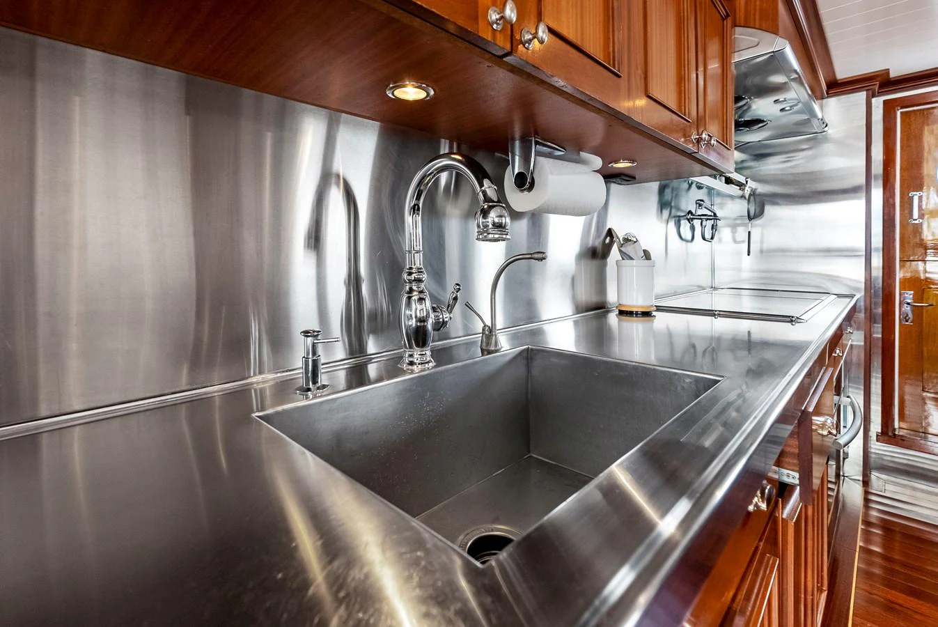 The yacht's galley features sleek stainless steel countertops and high-quality fixtures, providing a modern and functional cooking space. aboard CHANTICLEER Yacht for Sale