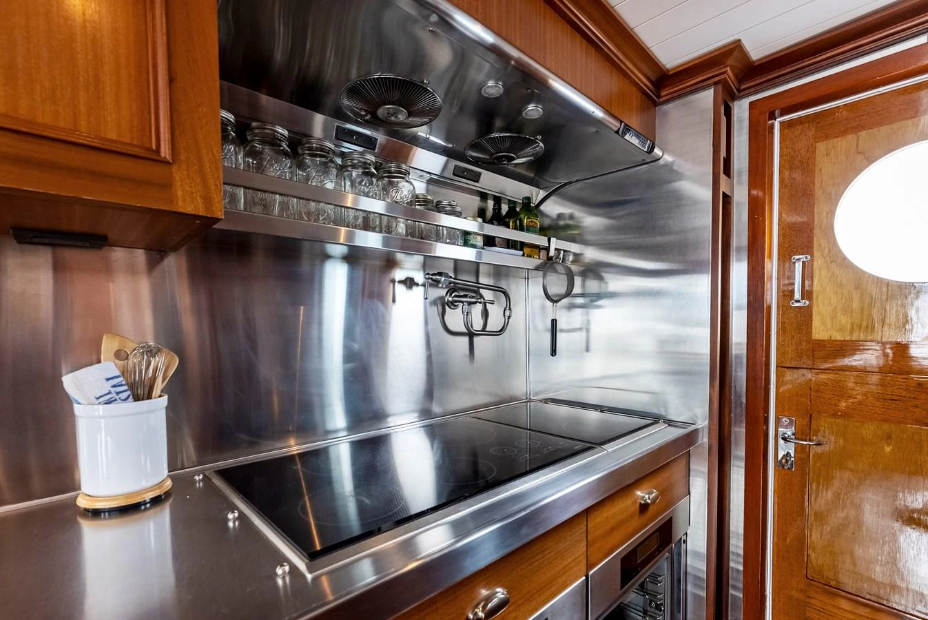 The galley features sleek stainless steel countertops and modern appliances, perfect for gourmet cooking. aboard CHANTICLEER Yacht for Sale
