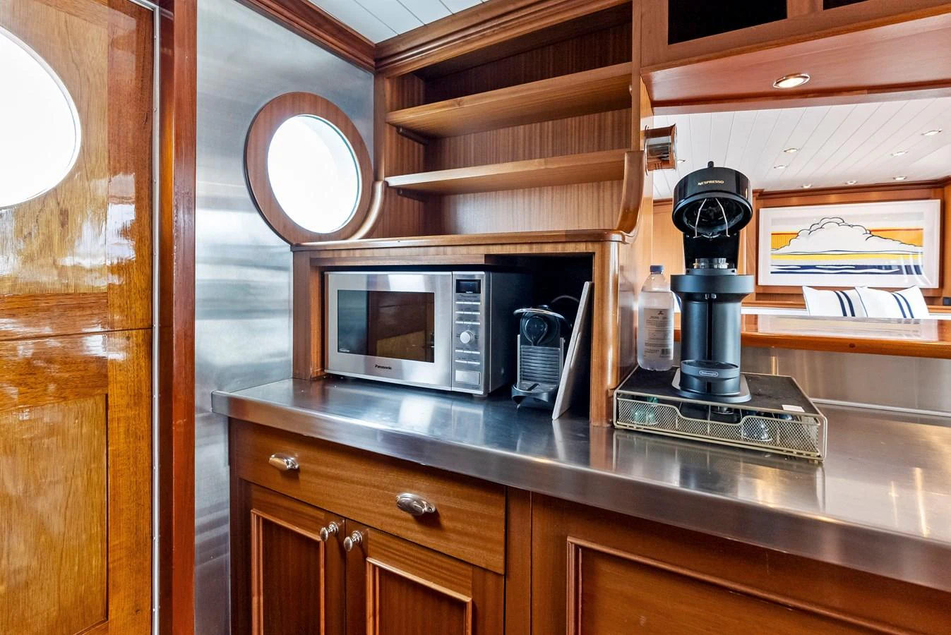 The galley features modern appliances and elegant wooden cabinetry, creating a warm and functional space. aboard CHANTICLEER Yacht for Sale