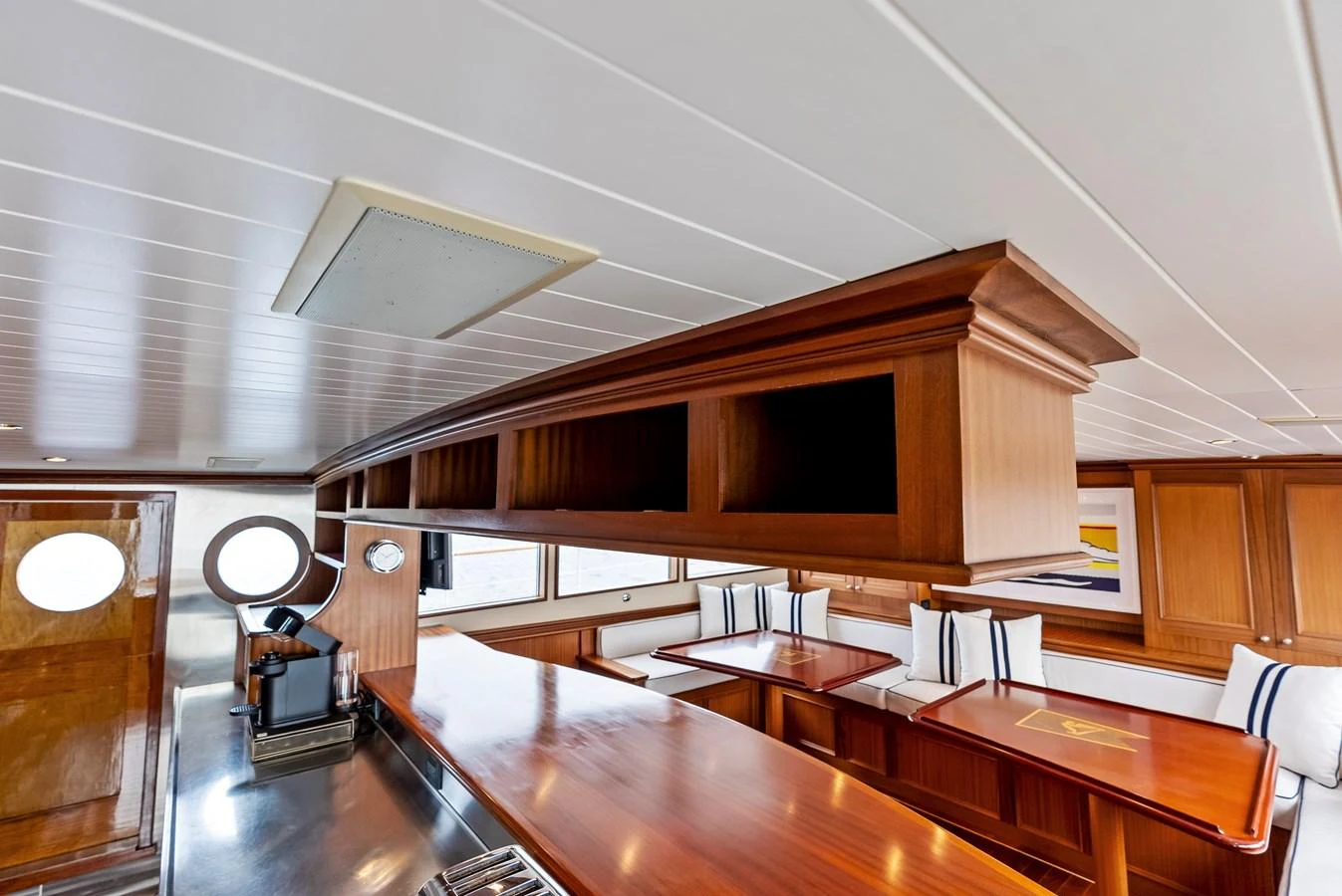 The yacht's galley features elegant wood finishes and ample seating for dining. aboard CHANTICLEER Yacht for Sale