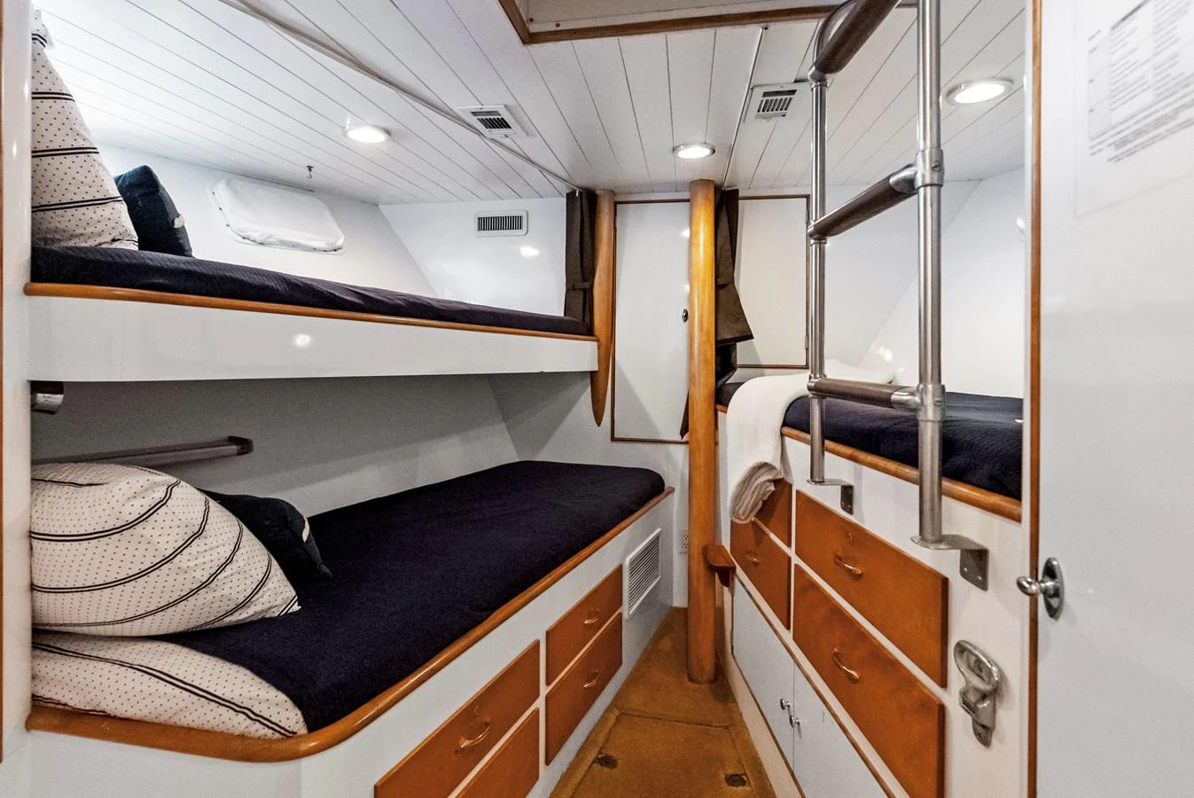 The cozy bunk room features neatly arranged beds and ample storage space. aboard CHANTICLEER Yacht for Sale