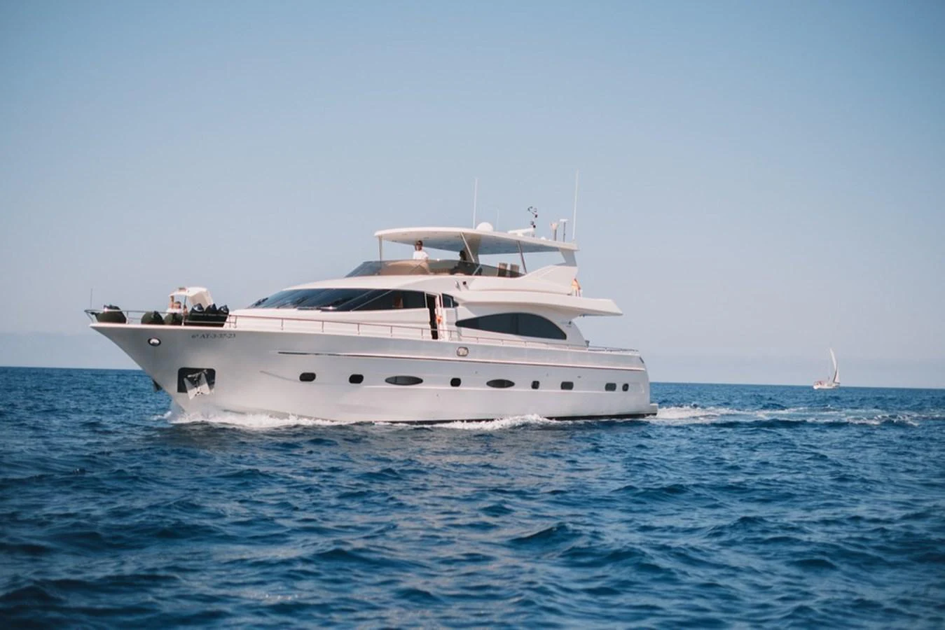 A sleek, modern yacht cruising on calm blue waters under a clear sky. aboard ASTONDOA 82 GLX Yacht for Sale