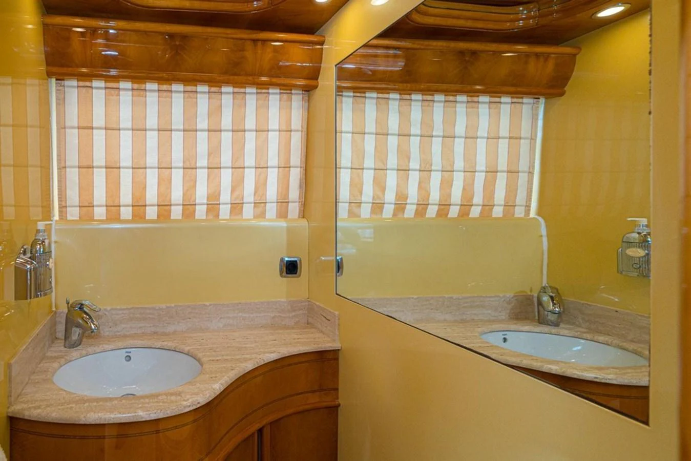 The yacht's bathroom features a sleek design with a large mirror and elegant fixtures. aboard ASTONDOA 82 GLX Yacht for Sale