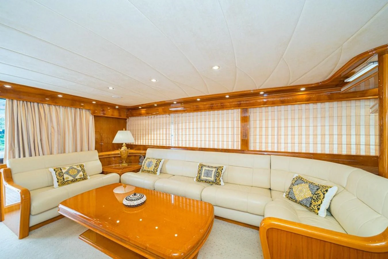 The salon features plush seating and elegant wood finishes, creating a cozy and inviting atmosphere. aboard ASTONDOA 82 GLX Yacht for Sale