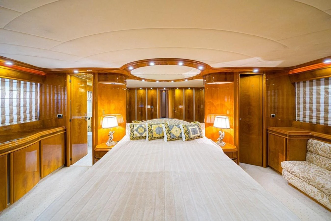 The master stateroom features a luxurious bed with elegant wood paneling and ambient lighting. aboard ASTONDOA 82 GLX Yacht for Sale