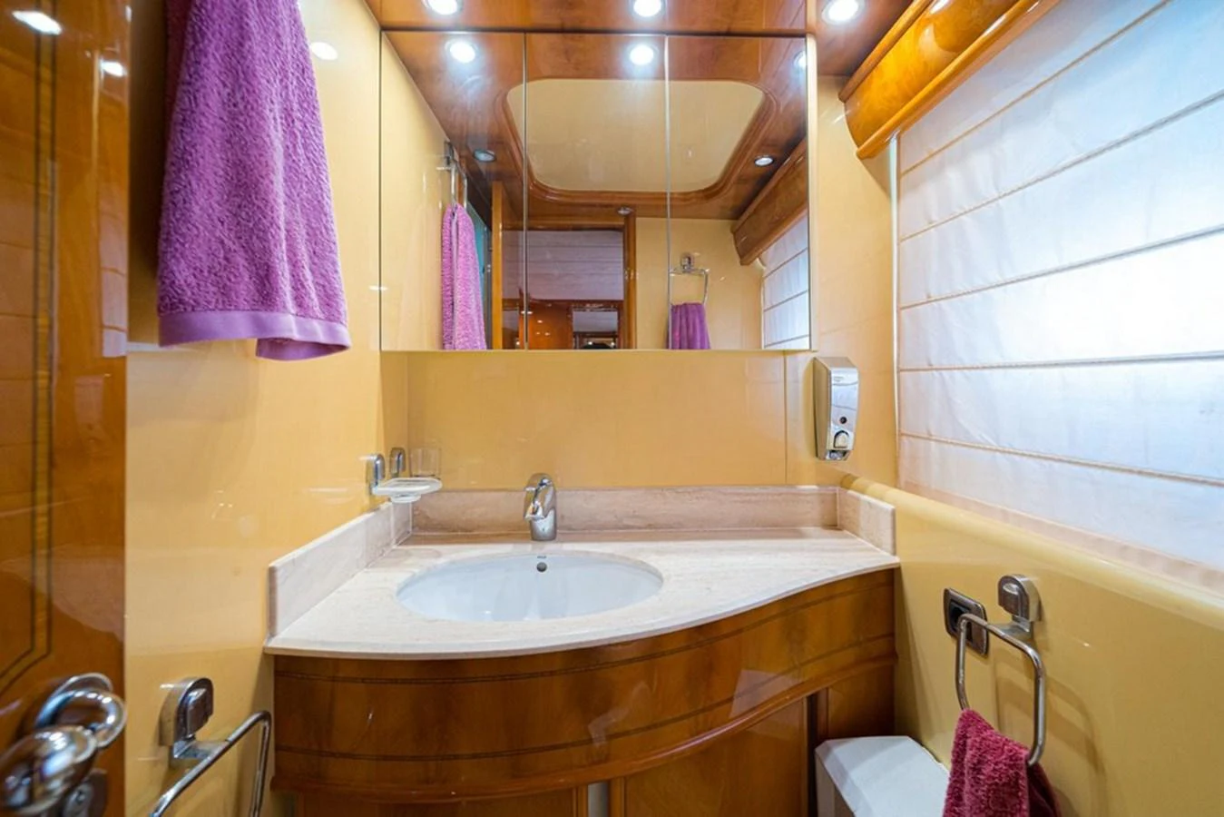 A luxurious yacht bathroom featuring a sleek vanity and modern fixtures. aboard ASTONDOA 82 GLX Yacht for Sale