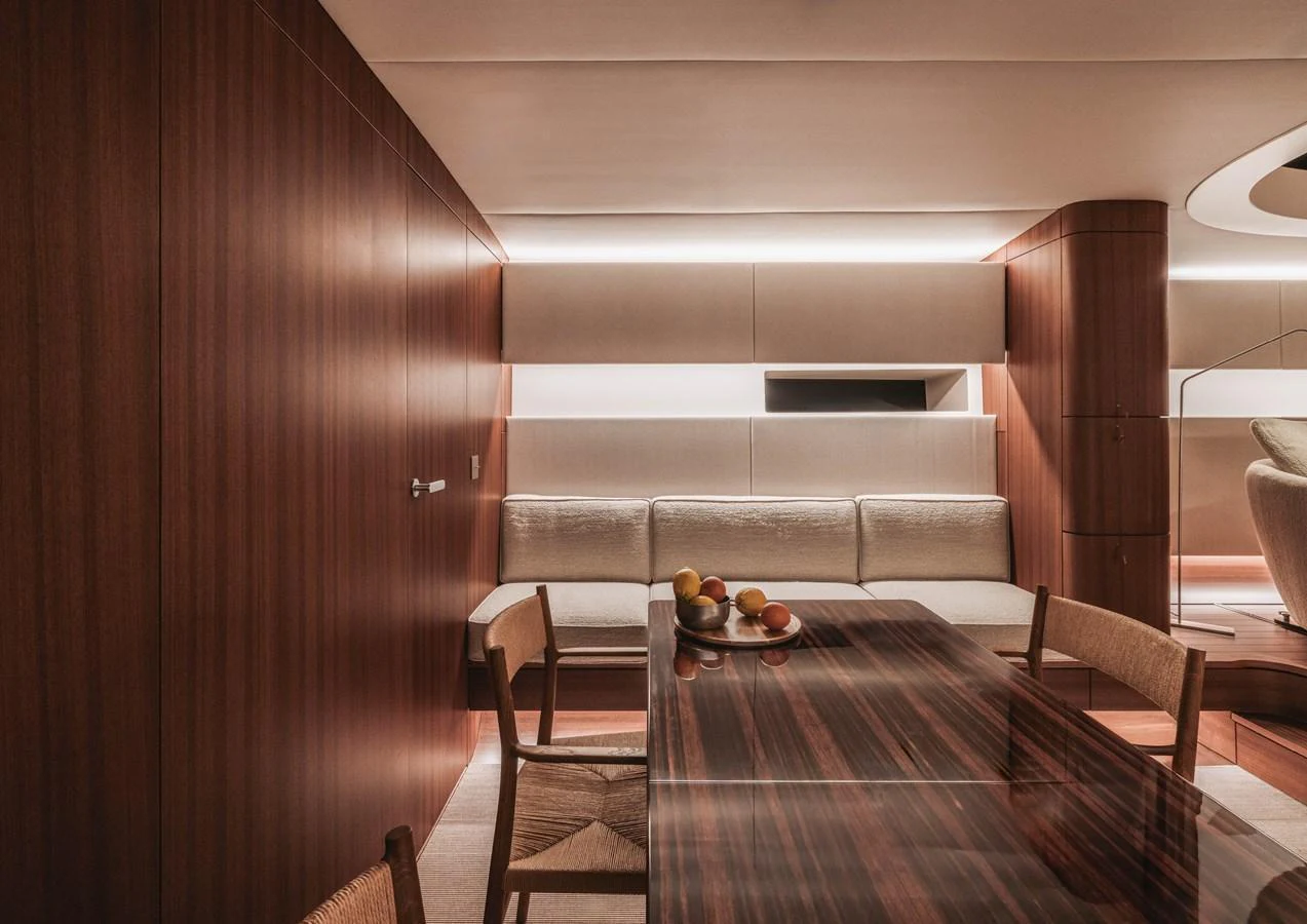 The yacht's dining area features elegant wood paneling and a sleek, modern design. aboard 2026 YYACHTS Y8 Yacht for Sale