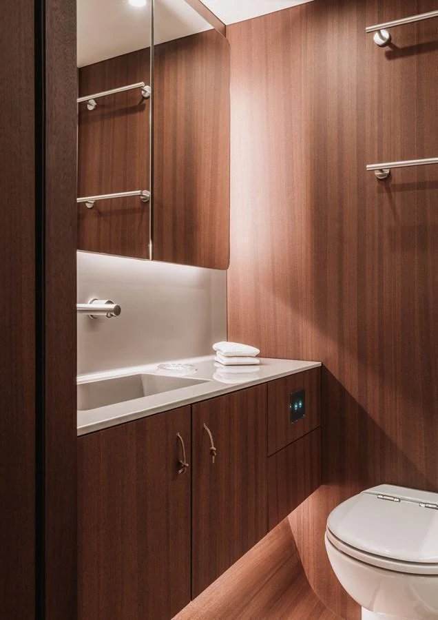 A sleek and modern yacht bathroom with wooden paneling and contemporary fixtures. aboard 2026 YYACHTS Y8 Yacht for Sale