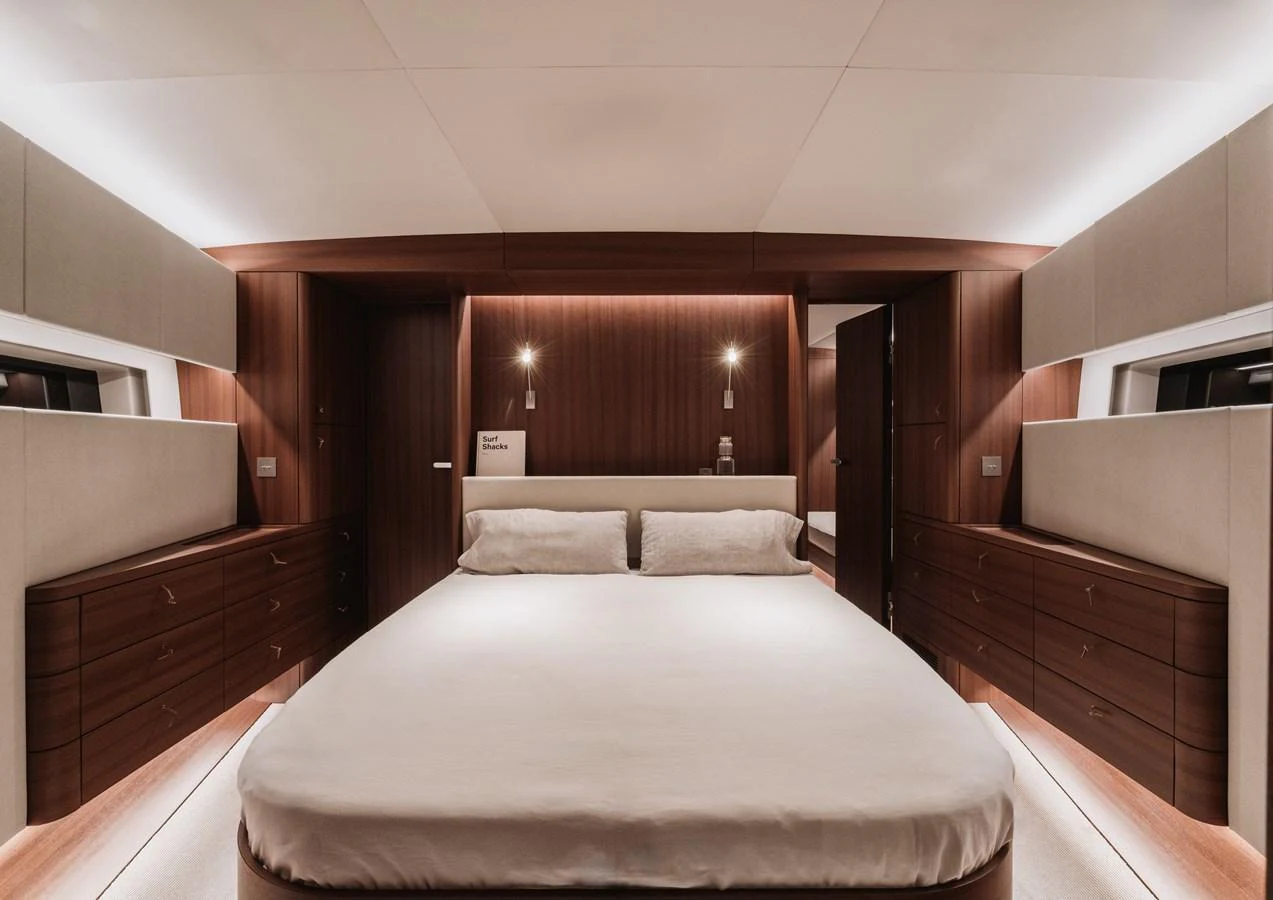 The master stateroom features a spacious bed with elegant wood paneling and ambient lighting. aboard 2026 YYACHTS Y8 Yacht for Sale