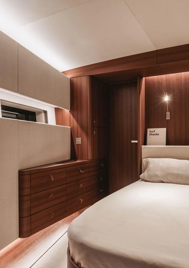 The stateroom features elegant wood paneling and modern lighting, creating a warm and inviting atmosphere. aboard 2026 YYACHTS Y8 Yacht for Sale