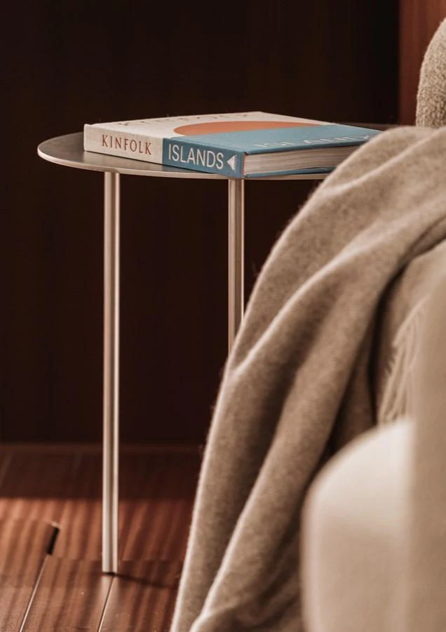 A cozy corner featuring a small side table with books and a soft blanket. aboard 2026 YYACHTS Y8 Yacht for Sale