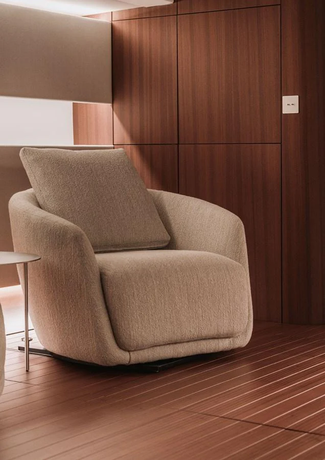 A cozy and modern seating area with a plush armchair and wooden paneling. aboard 2026 YYACHTS Y8 Yacht for Sale