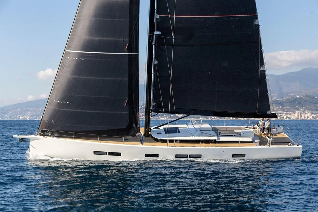 A sleek sailing yacht glides gracefully on the water with its dark sails contrasting against the bright hull. aboard 2026 YYACHTS Y7 Yacht for Sale