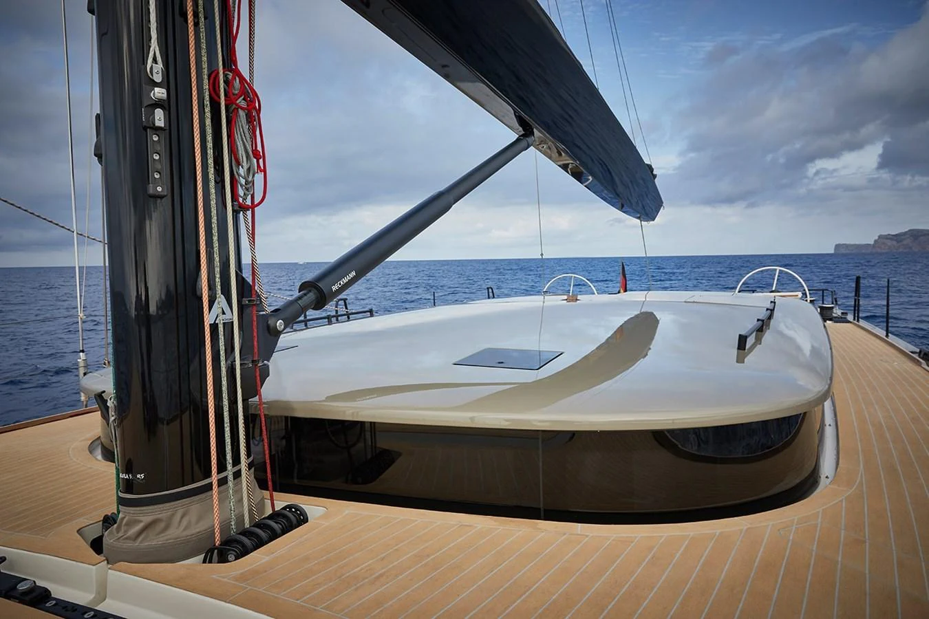 The image showcases the sleek and modern design of the yacht's deck with a focus on the mast and rigging. aboard 2026 YYACHTS Y7 Yacht for Sale