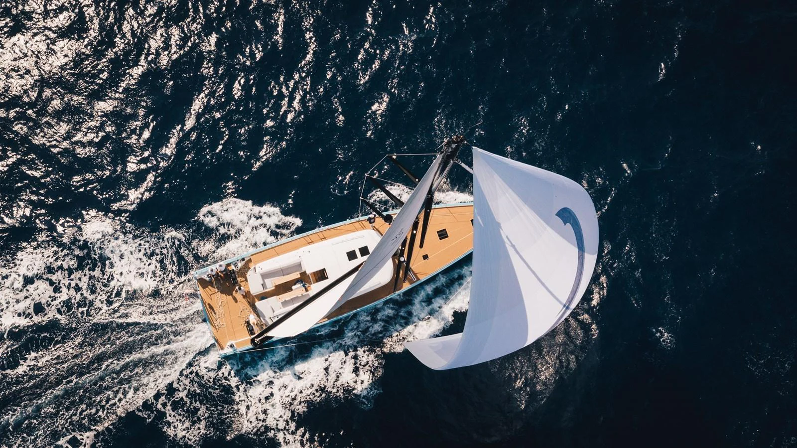 A sleek sailing yacht glides gracefully over deep blue waters, showcasing its elegant design and powerful sails. aboard 2026 YYACHTS Y7 Yacht for Sale