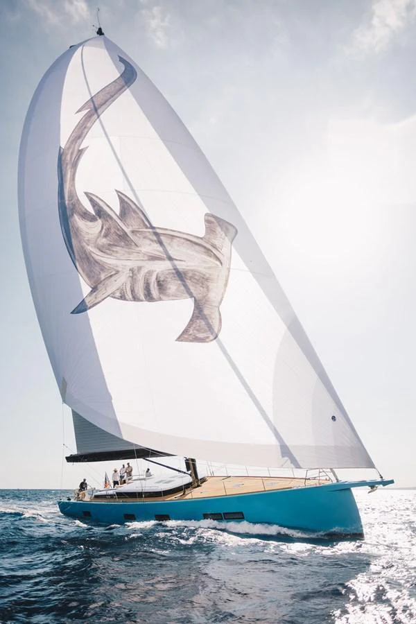 A sleek sailing yacht with a striking shark design on its sail glides gracefully on the open sea. aboard 2026 YYACHTS Y7 Yacht for Sale