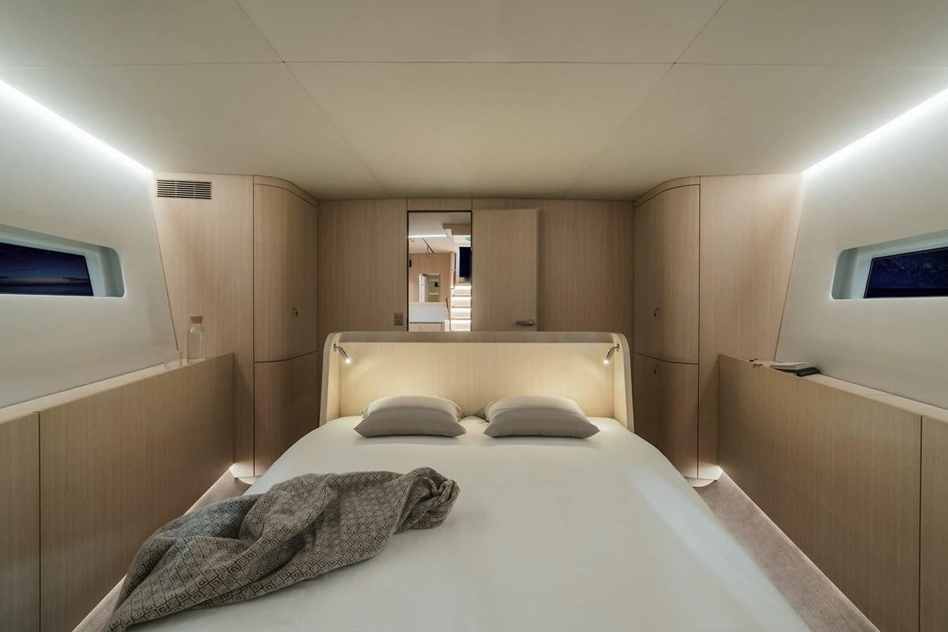 The master stateroom features a spacious bed with modern, minimalist design elements and soft lighting. aboard 2026 YYACHTS Y7 Yacht for Sale