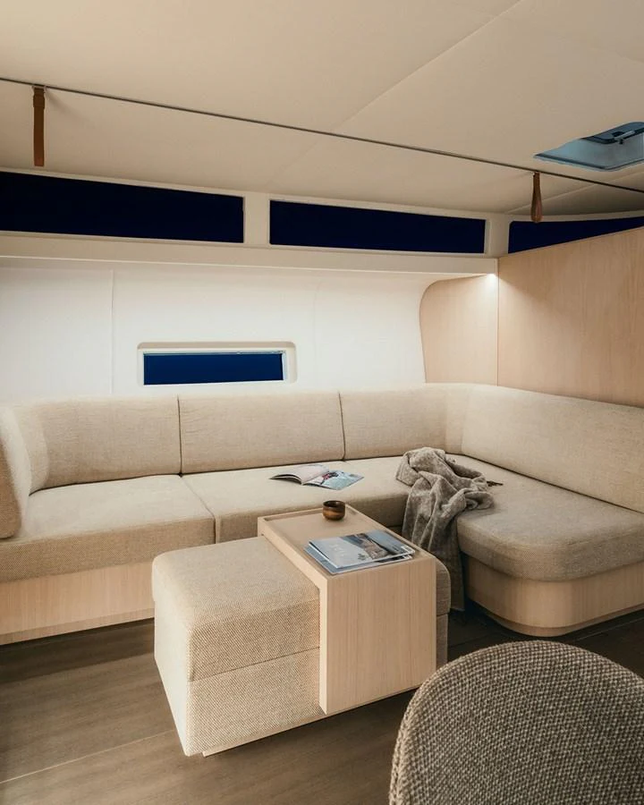 The salon features a cozy seating area with a modern, neutral-toned design. aboard 2026 YYACHTS Y7 Yacht for Sale