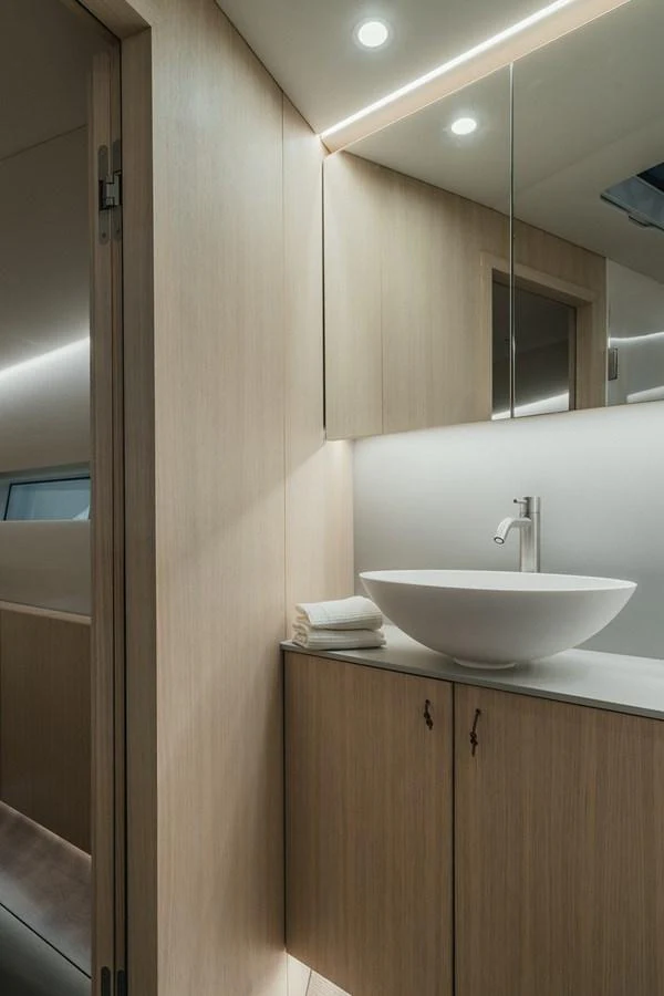 A sleek and modern yacht bathroom with minimalist design and elegant fixtures. aboard 2026 YYACHTS Y7 Yacht for Sale