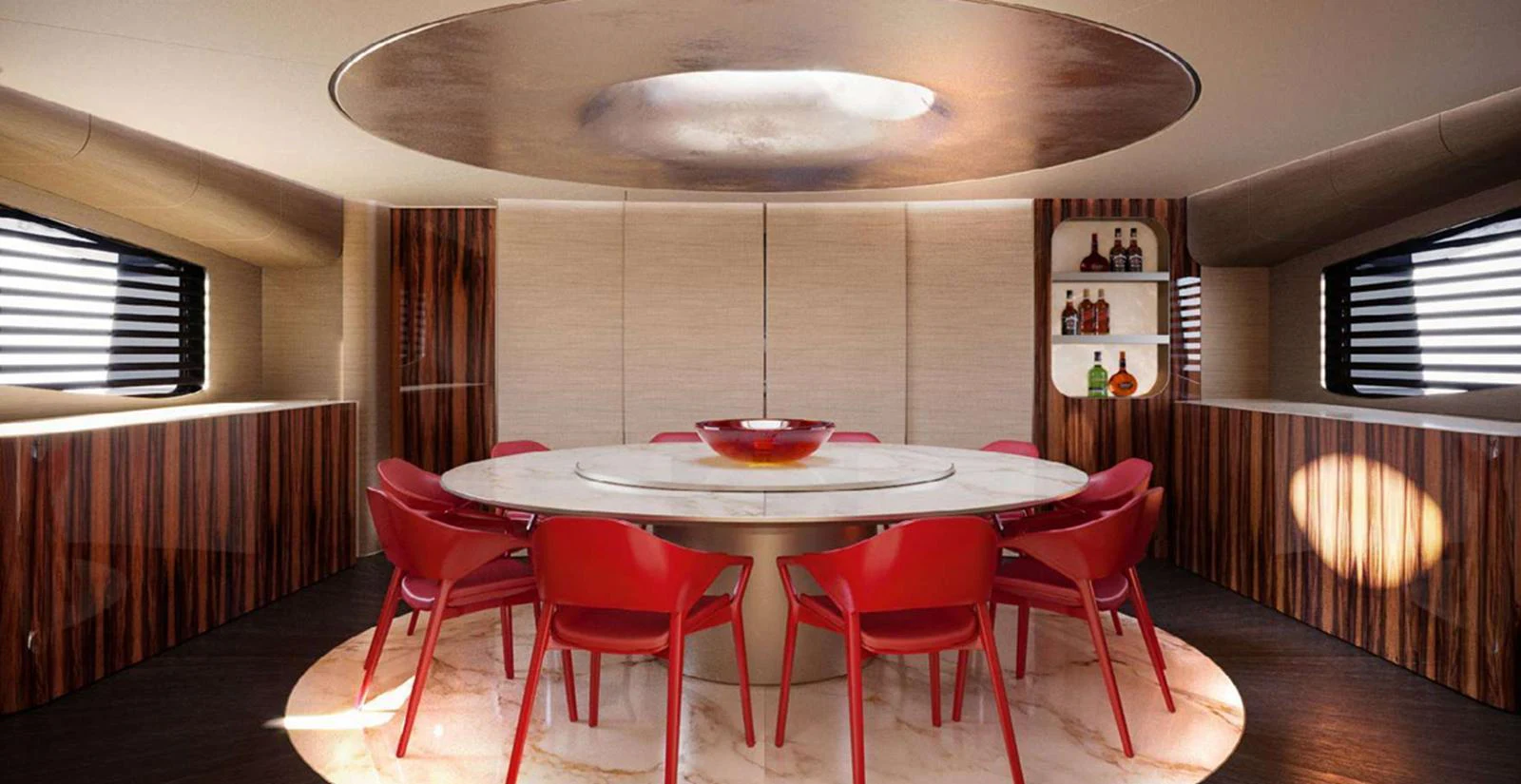 A luxurious dining area with a round table and vibrant red chairs, complemented by elegant wood paneling and ambient lighting. aboard T-EVO 120 Yacht for Sale