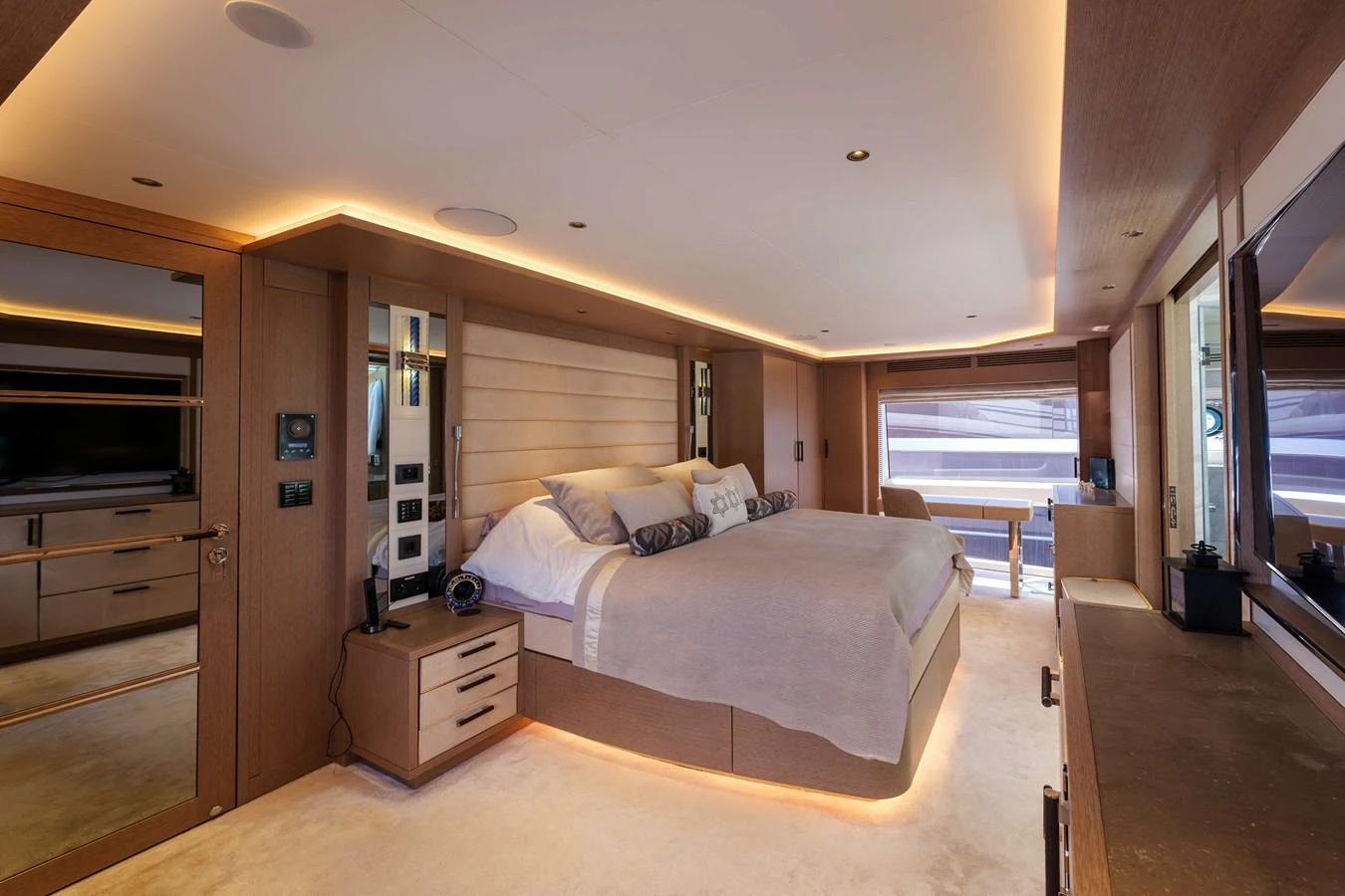 The master stateroom features a spacious bed, ambient lighting, and luxurious furnishings. aboard 2024 SIRENA 88 Yacht for Sale