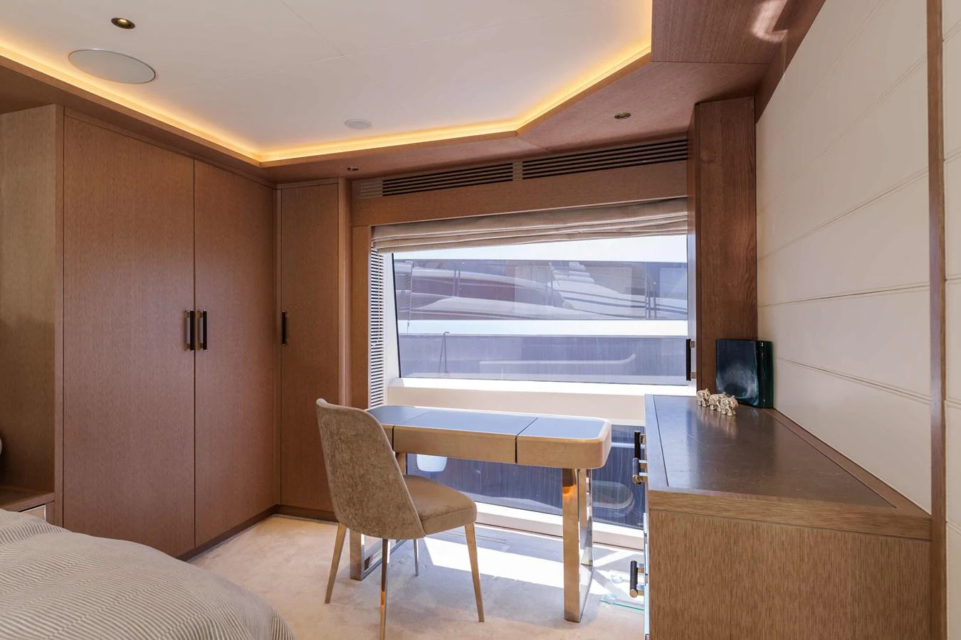 A luxurious stateroom featuring a desk area with a large window providing ample natural light. aboard 2024 SIRENA 88 Yacht for Sale