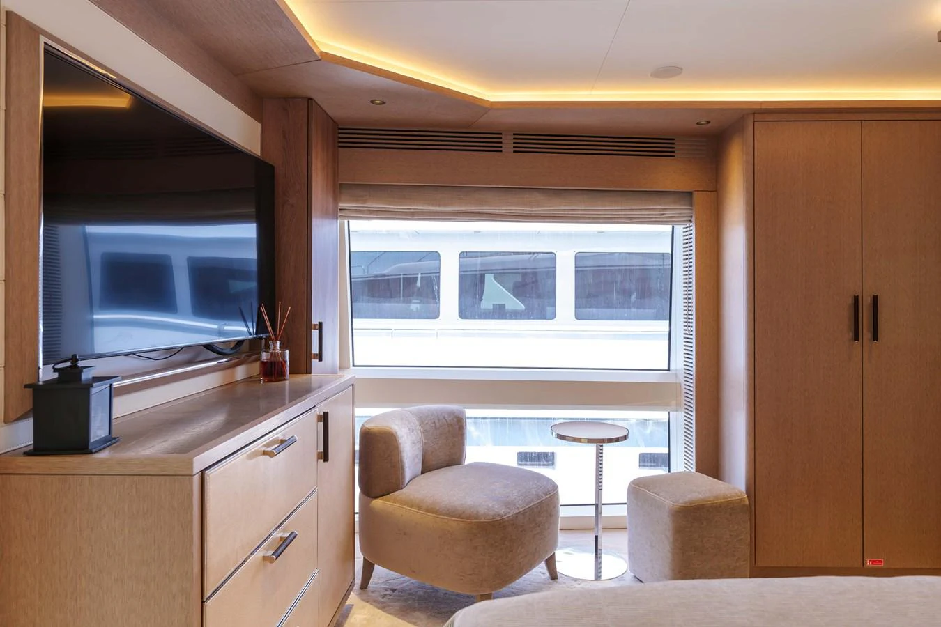 The stateroom features elegant furnishings and a large window with a view of the water. aboard 2024 SIRENA 88 Yacht for Sale