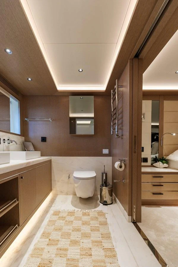 This luxurious yacht bathroom features modern fixtures and elegant wood paneling. aboard 2024 SIRENA 88 Yacht for Sale
