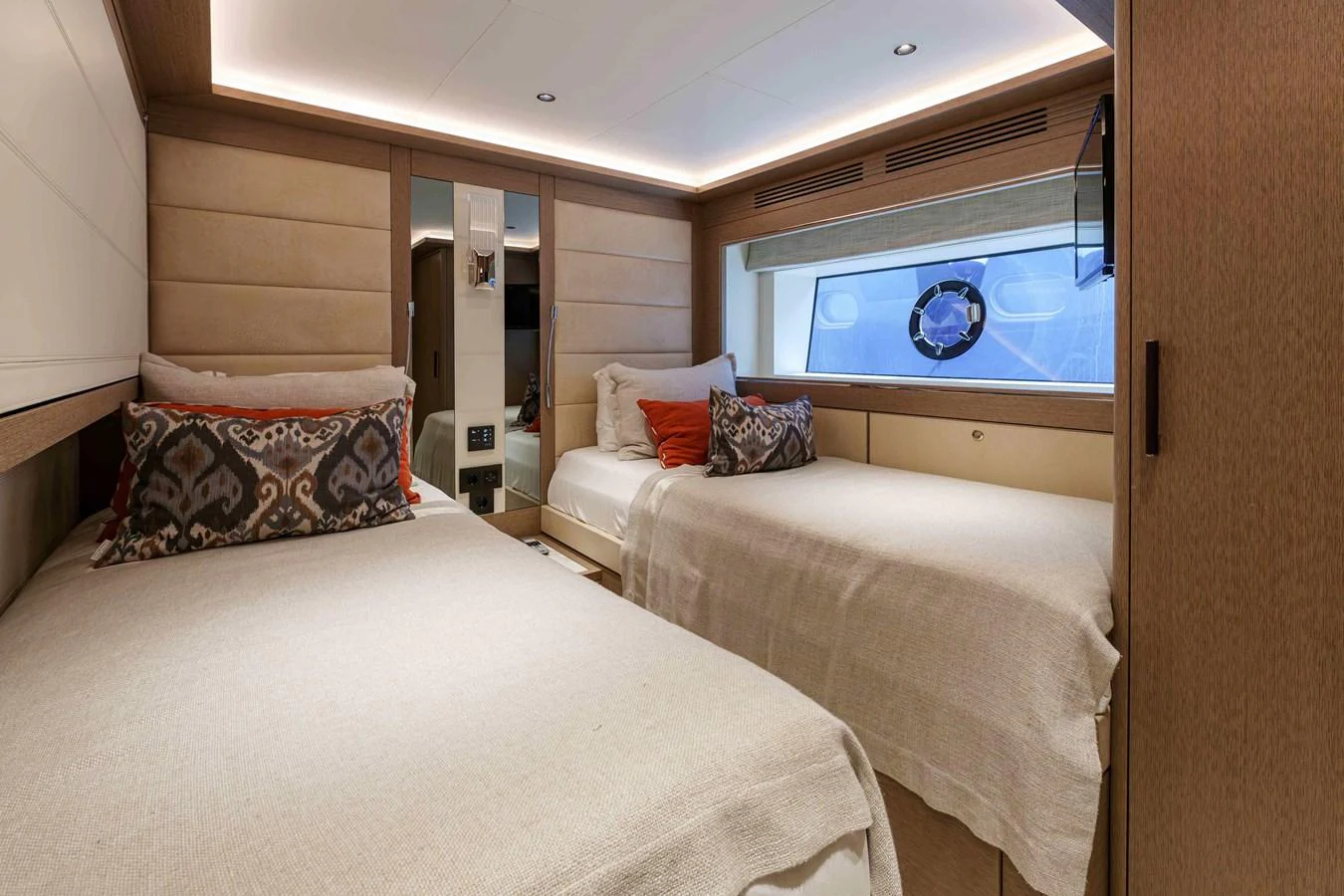 The guest stateroom features twin beds with elegant bedding and a large window providing natural light. aboard 2024 SIRENA 88 Yacht for Sale